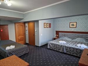 Postel nebo postele na pokoji v ubytování Danube Hotel & Spa