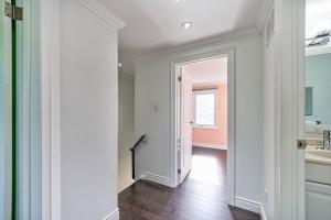an empty hallway with a bathroom and a sink at 4BR Scarborough Gem, Freshly Renovated, 7 Car Parking in Toronto +48 photos