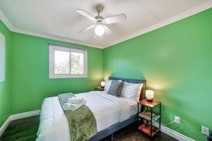 a green bedroom with a bed with a ceiling fan at 4BR Scarborough Gem, Freshly Renovated, 7 Car Parking in Toronto