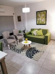 a living room with a green couch and a table at Apart Luro III in Santa Rosa