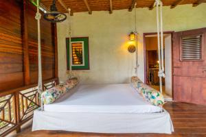 a bed in a room with a swing at Sweetfield Manor in Bridgetown +93 photos