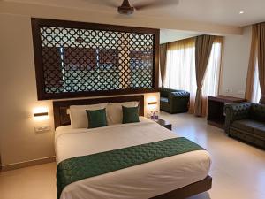 una camera da letto con un letto e un soggiorno di Hotel Rameswaram Grand a Rāmeswaram
