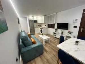 a living room with a couch and a table at 2ª planta D Apartamento Juan Robledo en centro ciudad, INTERIOR in Andújar