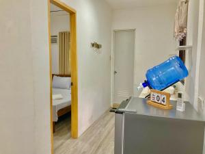 a room with a table with a clock on it at RRJ Bungalow 2 1BR,2AC 4 mins walk to the beach in General Luna