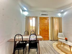 a dining room with a table and chairs at RRJ Bungalow 2 1BR,2AC 4 mins walk to the beach in General Luna +15 photos