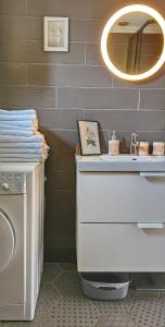 a bathroom with a white sink and a mirror at Apartment Mint&Rose in Risan +93 photos