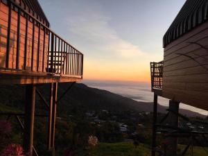 a balcony of a building with the sunset in the background at Baan Phak Sai Lom Nao in Ban Maeo Thap Boek +9 photos