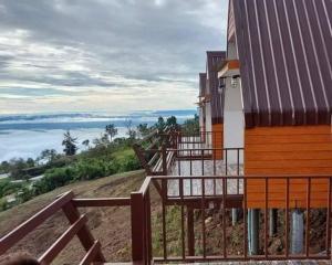 a house with a staircase leading up to a building at Baan Phak Sai Lom Nao in Ban Maeo Thap Boek
