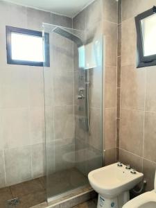a bathroom with a shower with a toilet and a sink at Acacias Mina Clavero in Mina Clavero +53 photos