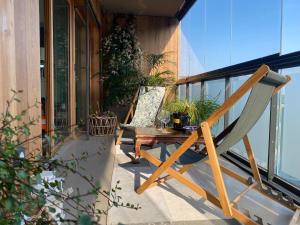 a chair and a table on a balcony at Fred Appartement Lille Centre in Lille