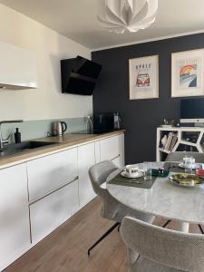 a kitchen with a table and chairs in a room at Fred Appartement Lille Centre in Lille +10 photos