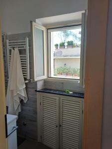 a bathroom with a window and a counter with a sink at Anita's House in Rome +27 photos