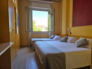 Posteľ alebo postele v izbe v ubytovaní Mokinba Hotels Sant'Ambroeus