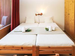 two beds in a room with flowers on them at Apartment Rosablanche C22 by Interhome in Siviez