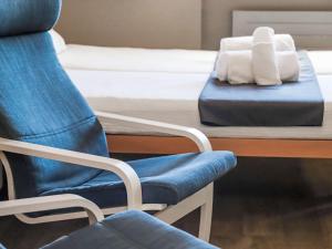 a room with a chair and a table and a bed at Apartment Rosablanche C66 by Interhome in Siviez +16 photos