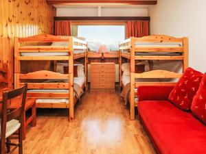 a room with four bunk beds and a couch at Apartment Rosablanche D51 by Interhome in Siviez