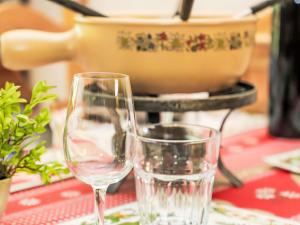 two wine glasses sitting on a table with a pot at Apartment Rosablanche D51 by Interhome in Siviez +21 photos