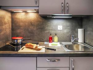 a kitchen counter with a cutting board and a sink at Apartment Rosablanche B22 by Interhome in Siviez +16 photos