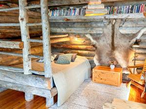 ein Schlafzimmer mit einem Bett in einer Blockhütte in der Unterkunft Holiday Home Nanguvilla by Interhome in Veskoniemi