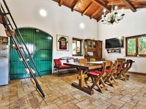 a kitchen and dining room with a table and chairs at Holiday Home Malu Sun II by Interhome in Brodarica