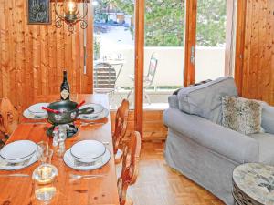 a living room with a table and a couch at Apartment Grand Place 5 by Interhome in Nendaz