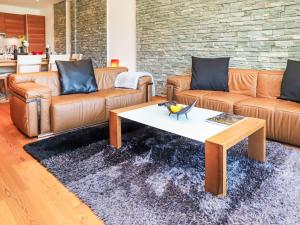 a living room with couches and a coffee table at Apartment Rosablanche D 203A by Interhome in Siviez