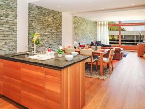 a kitchen and living room with a stone wall at Apartment Rosablanche D 203A by Interhome in Siviez
