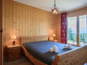 a bedroom with a bed with two towels on it at Apartment Plein Sud 3 by Interhome in Ovronnaz