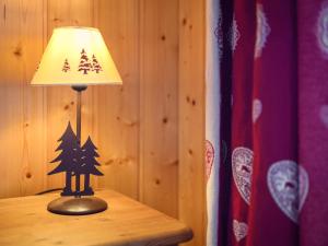 a lamp sitting on a table next to a flag at Apartment Plein Sud 3 by Interhome in Ovronnaz