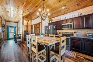 a kitchen with a wooden table and a dining room at Back In Black in Pigeon Forge