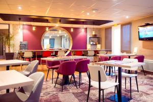 勒勒莱克凯尔于永勒莱克胡昂布雷斯特布里特酒店的餐厅设有桌椅和镜子