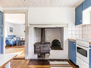 an open kitchen with a stove in the middle at Holiday Home Svenstorp by Interhome in Ryssby