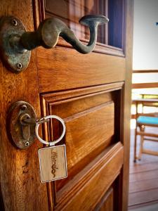 a wooden door with a lock and a tag on it at Mistral-Patmos in Patmos