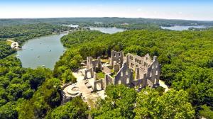 an aerial view of an old castle and a river at 151 Upper Monarch Cove 5E in Lake Ozark