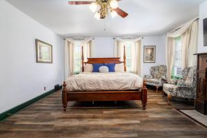 a bedroom with a bed and a ceiling fan at The Historic Reeds Mill Inn in Steubenville