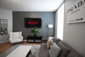 a living room with a couch and a tv at Fashionable 1-Bedrm Apt 15 Min to Manhattan in Hoboken
