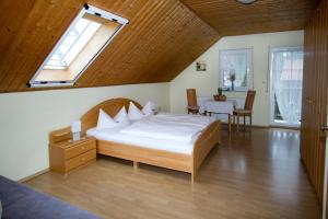 a bedroom with a large bed and a window at Ferienpension Kühner in Römhild