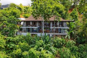 an aerial view of a house surrounded by trees at Bali Villa Jungle Paradise - Uvita in Uvita