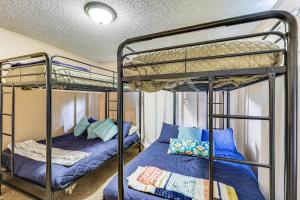 a bedroom with two bunk beds with blue pillows at Rural Escape Near Lake Ouachita with Gas Grill! in Pearcy