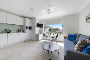 a living room with a couch and a table at Modern and Airy Belgravia Living in London