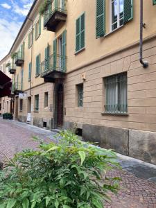 a building on a street with a bush in front of it at La Corte in Alba