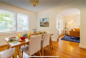a dining room and living room with a table and chairs at Historic Home, Modern Amenities- 15 Minutes to Downtown Chattanooga- Perfect for Families in Signal Mountain