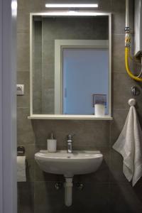a bathroom with a sink and a mirror at Apartman Ivice in Gornji Milanovac