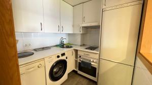 a kitchen with a refrigerator and a washing machine at House Samaniego 12 in Madrid