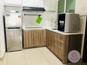 a kitchen with a refrigerator and a microwave at The Majestic Condo Ipoh Home Fairy 5 in Ipoh