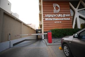 a car parked in front of a white diamond hotel at Wow Diamond Hotel in Jeddah