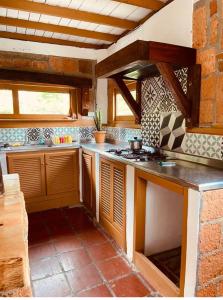 a kitchen with a counter and a stove top oven at Villa carmelita in Jardin