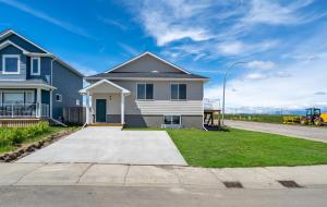 a house on the side of a road at Centre Peak View I Sleep 8 I 50 TV I Full Kitchen in Pincher Creek