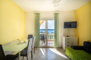 a living room with a view of the ocean at Adriatic Guest House Milić in Gornji Karin