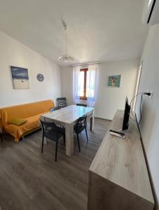 a living room with a table and a couch at Appartamento Casa Vittoria - La Ciaccia in La Ciaccia +22 photos
